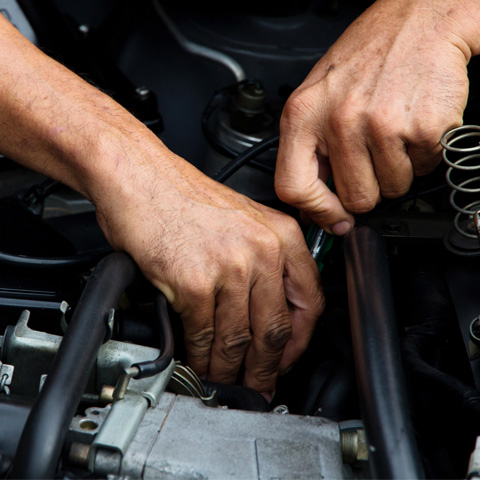 Technician working on an engine bay